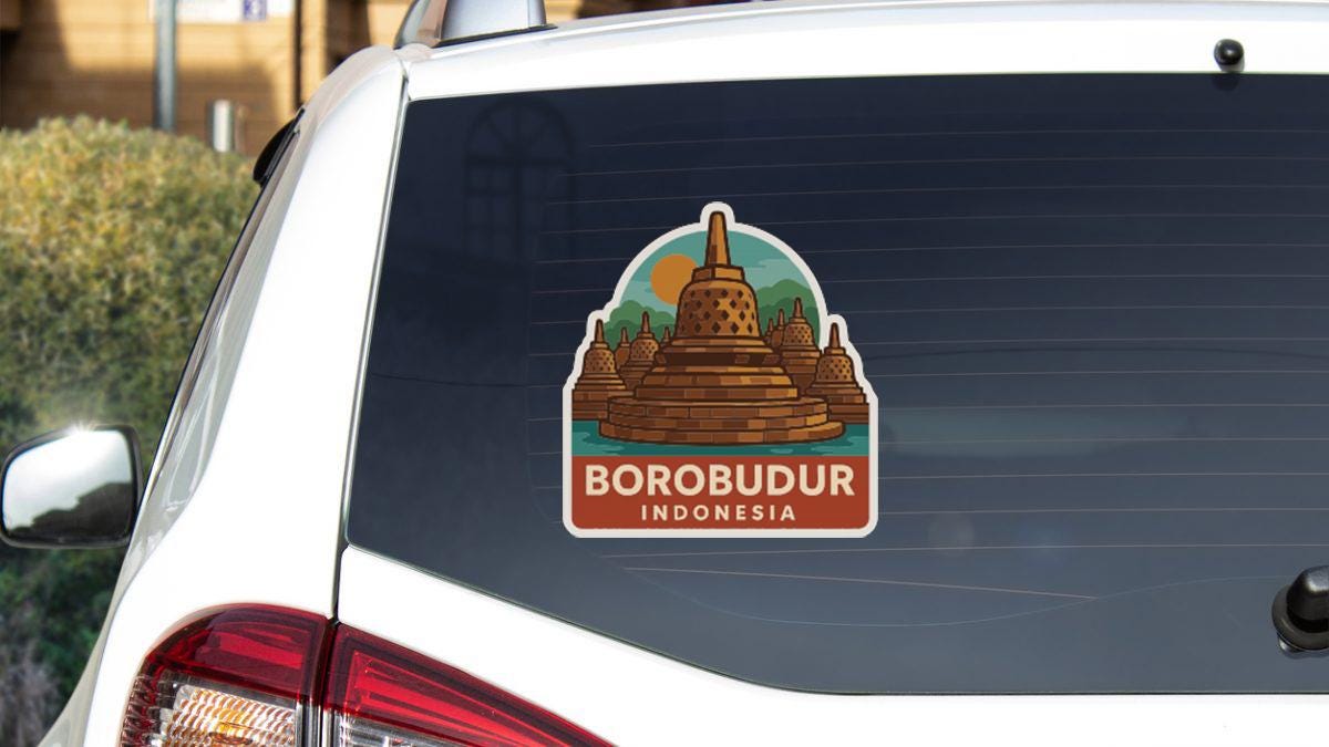 A sticker on the rear window of a white car, depicting Borobudur, a famous landmark in Indonesia.