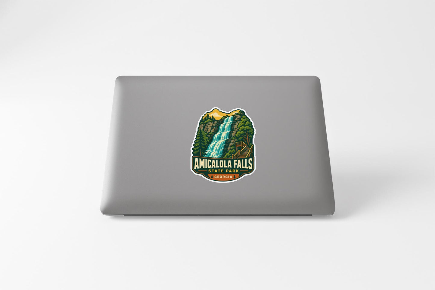 a sticker or decal of Amicalola Falls on the back of a laptop computer.