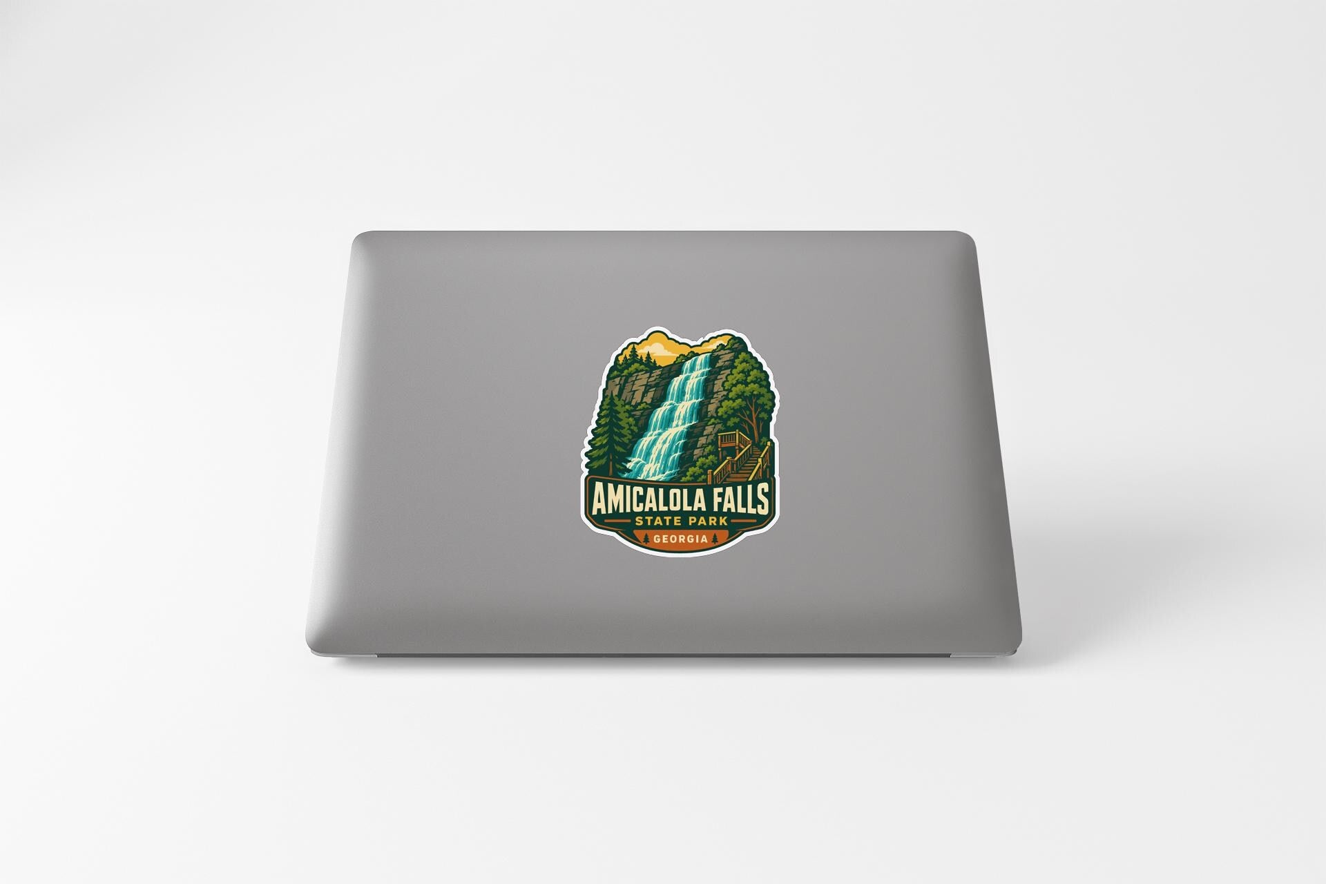 a sticker or decal of Amicalola Falls on the back of a laptop computer.