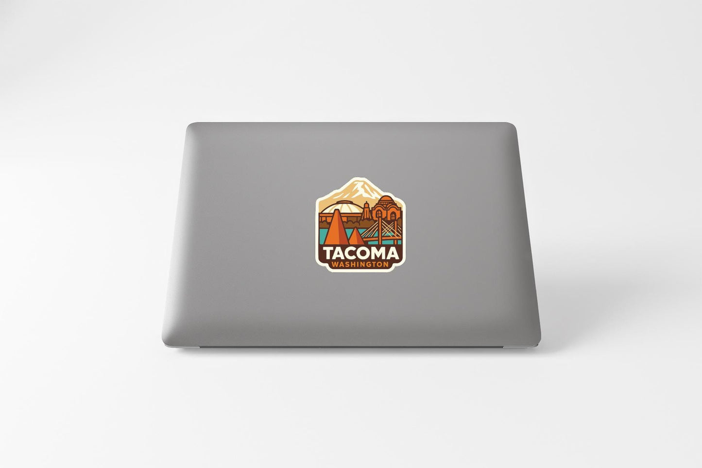 a sticker with a mountain and a bridge on a laptop.