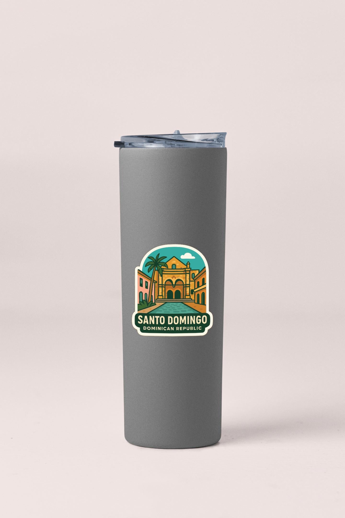 A gray insulated tumbler with a sticker depicting the Santo Domingo, the capital city of the Dominican Republic.