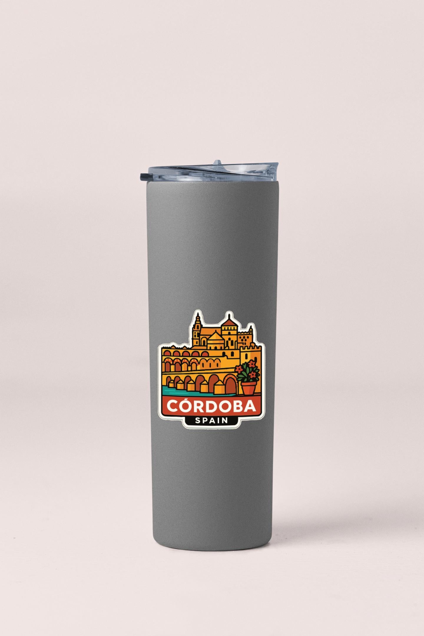 A gray insulated tumbler with a sticker depicting a cityscape and the text "CORDOBA, SPAIN".