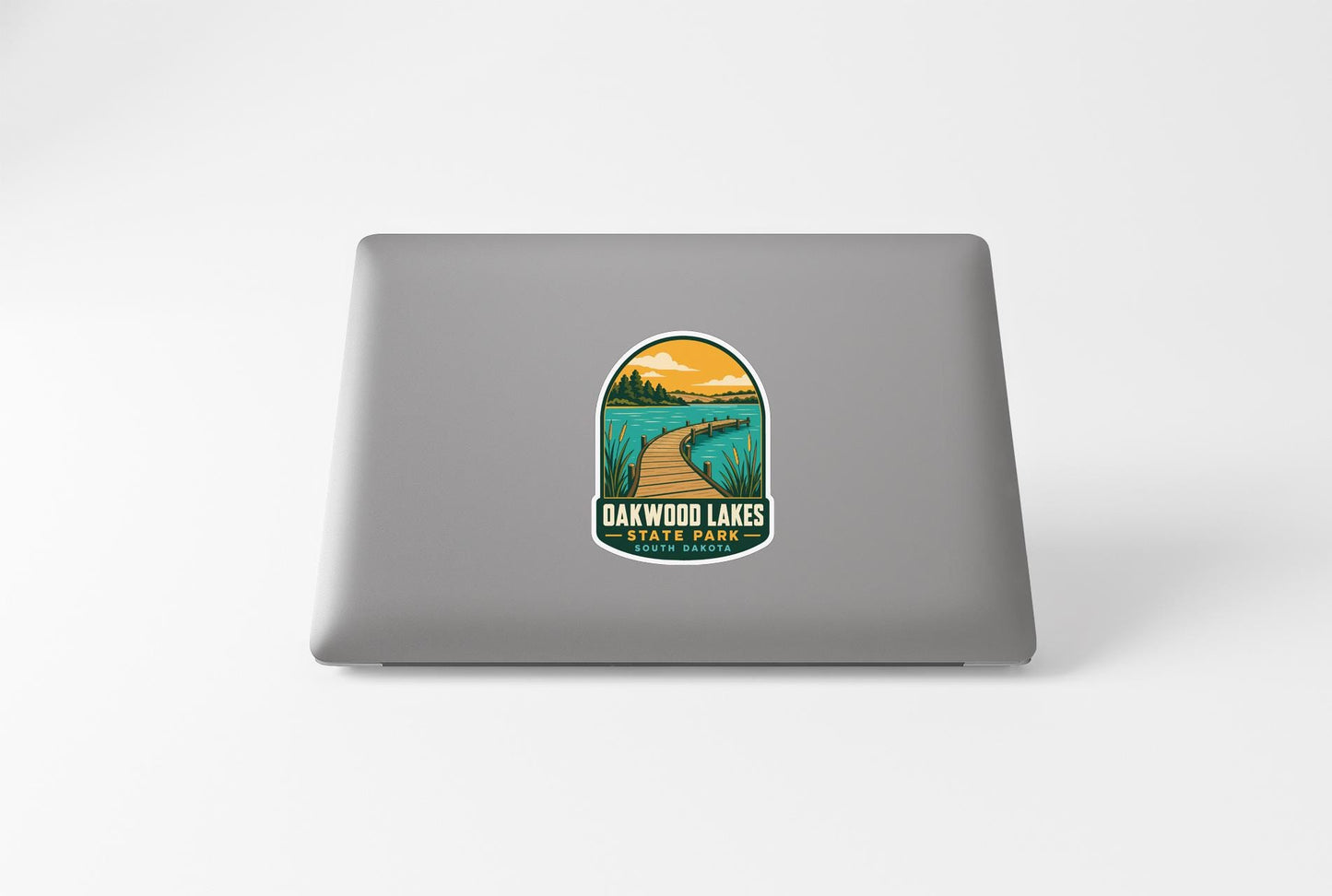 A sticker on the back of a laptop, depicting a scenic view of Oakwood Lakes State Park.