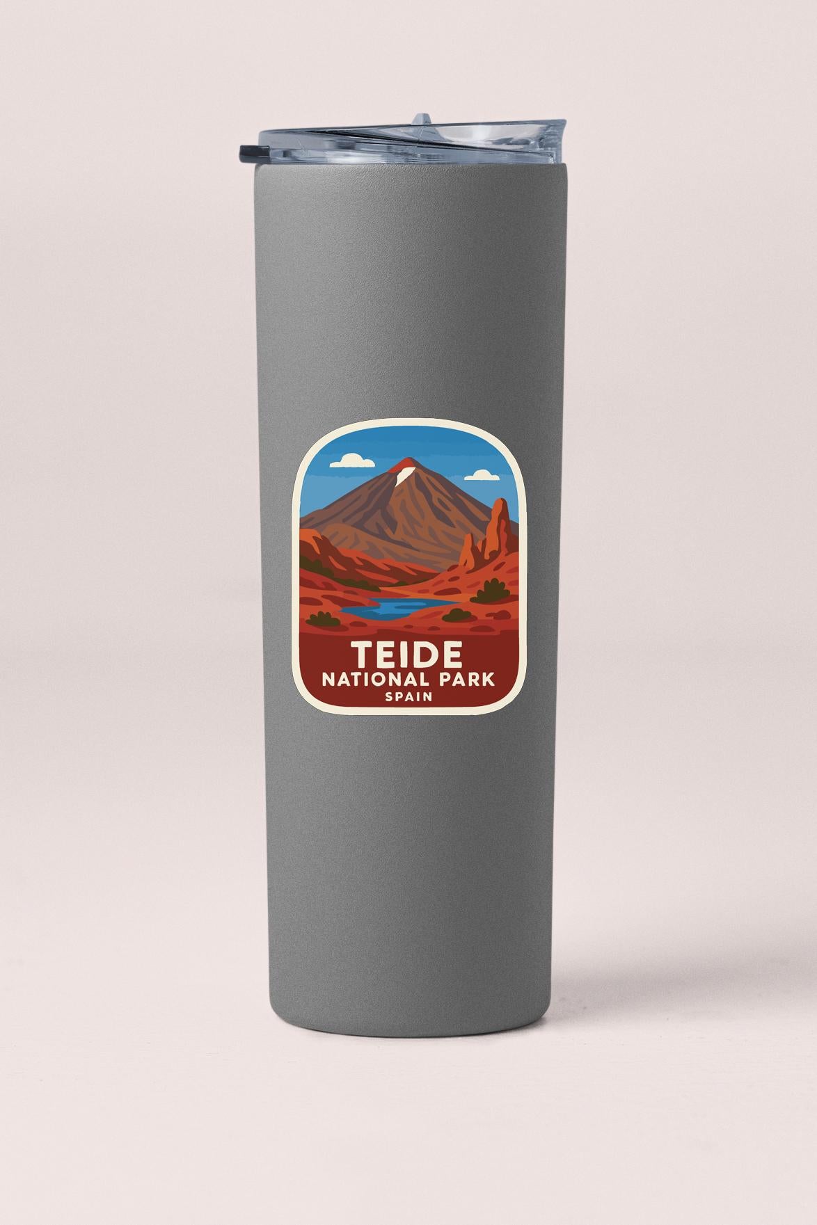 A gray tumbler with a label that features an illustration of a mountain landscape and the text "TEIDE NATIONAL PARK" printed on it.