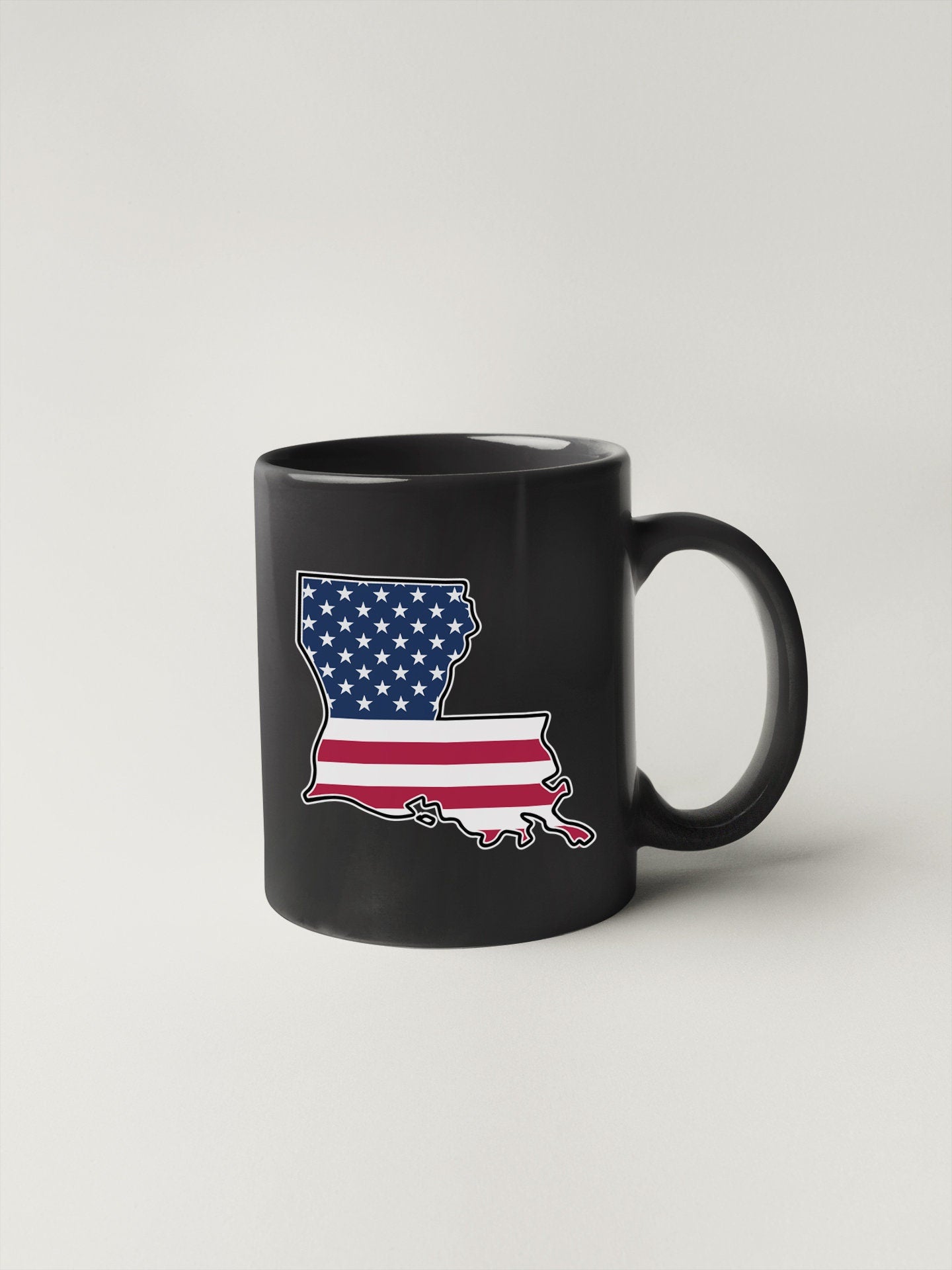 a black coffee mug with an american flag on it