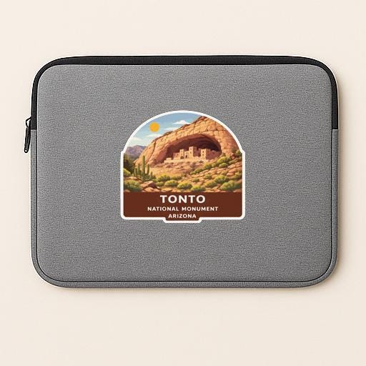 A gray laptop sleeve with a sticker of the Tonto National Monument in Arizona.