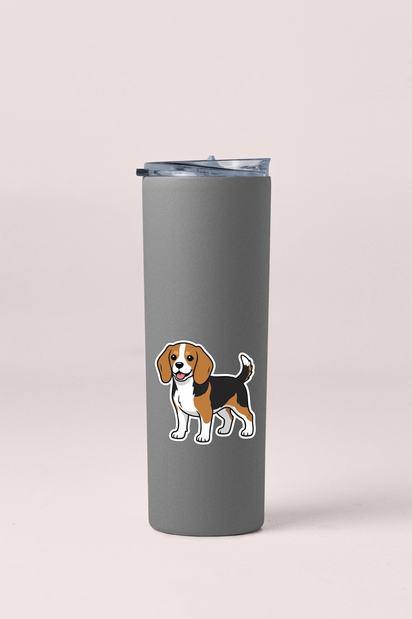 A gray insulated tumbler with a sticker of a cartoon dog on it.