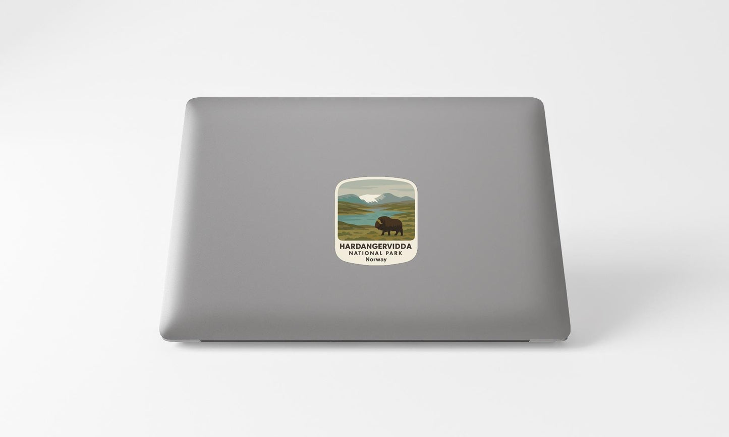A sticker on the back of a laptop, depicting a bison in a natural landscape.