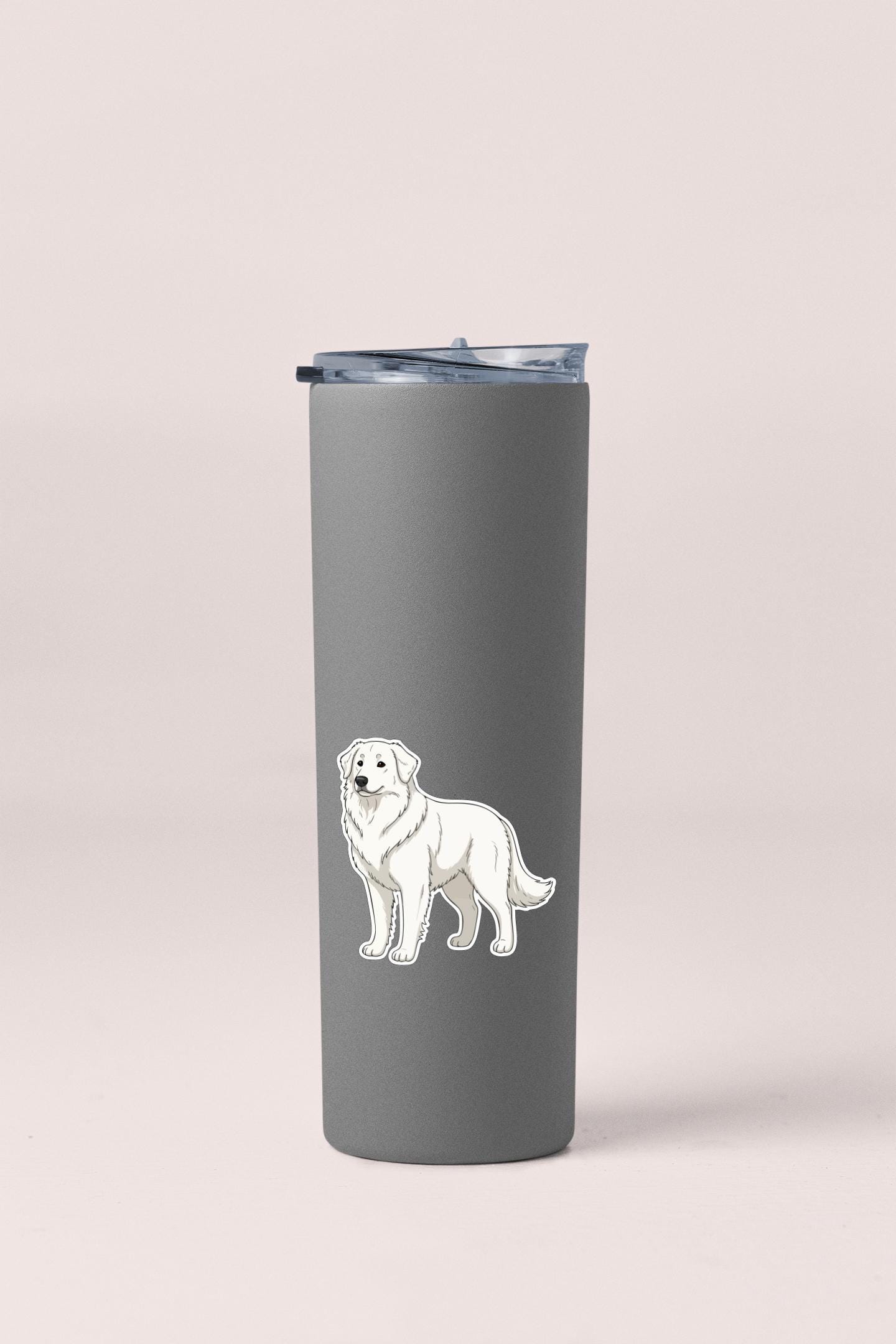 A gray insulated tumbler with a sticker of a white dog on it.