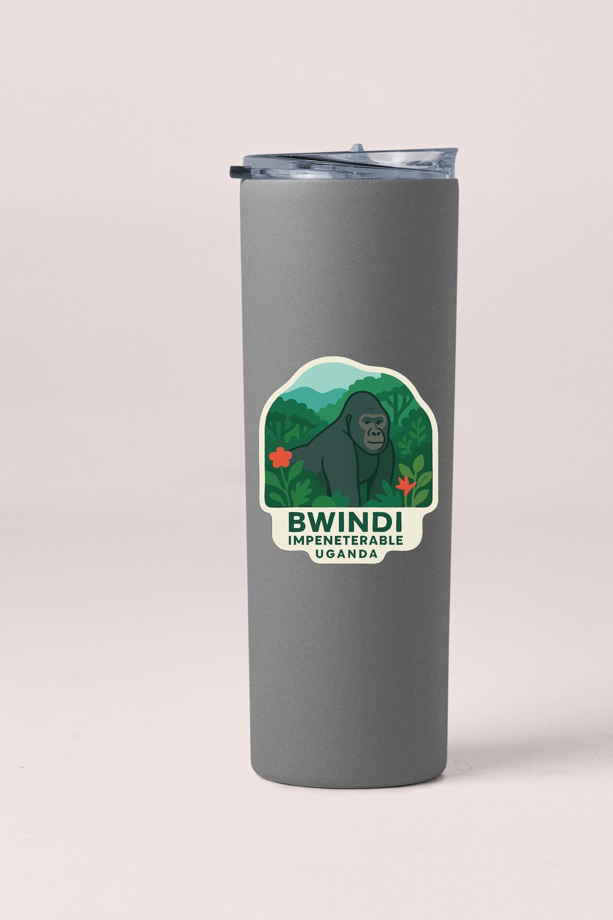 A gray tumbler with a sticker depicting a gorilla in a jungle setting.
