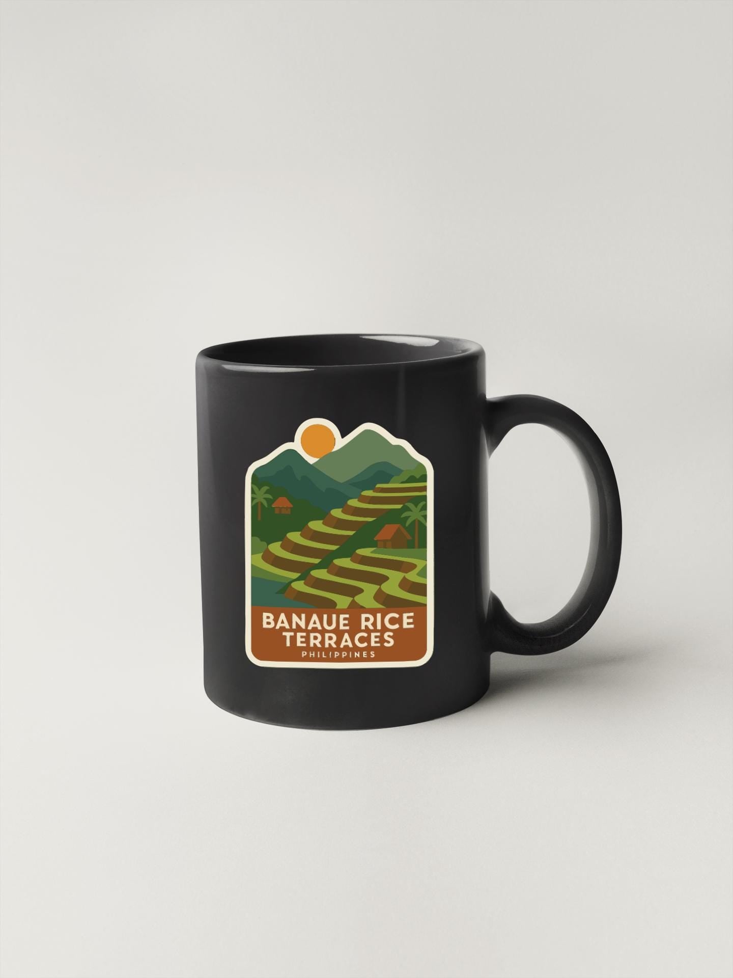 A black coffee mug with a label that says "Banau Rice Terraces Philippines".