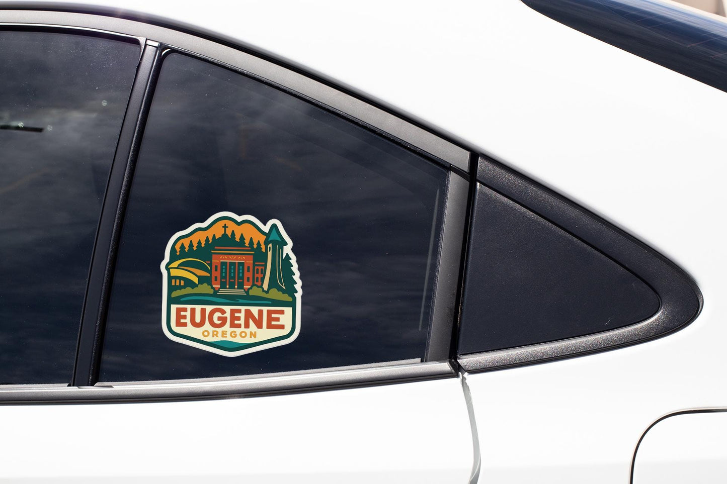 A sticker on the side of a car window, featuring an illustration of a mountain and the text "EUGENE OREGON".