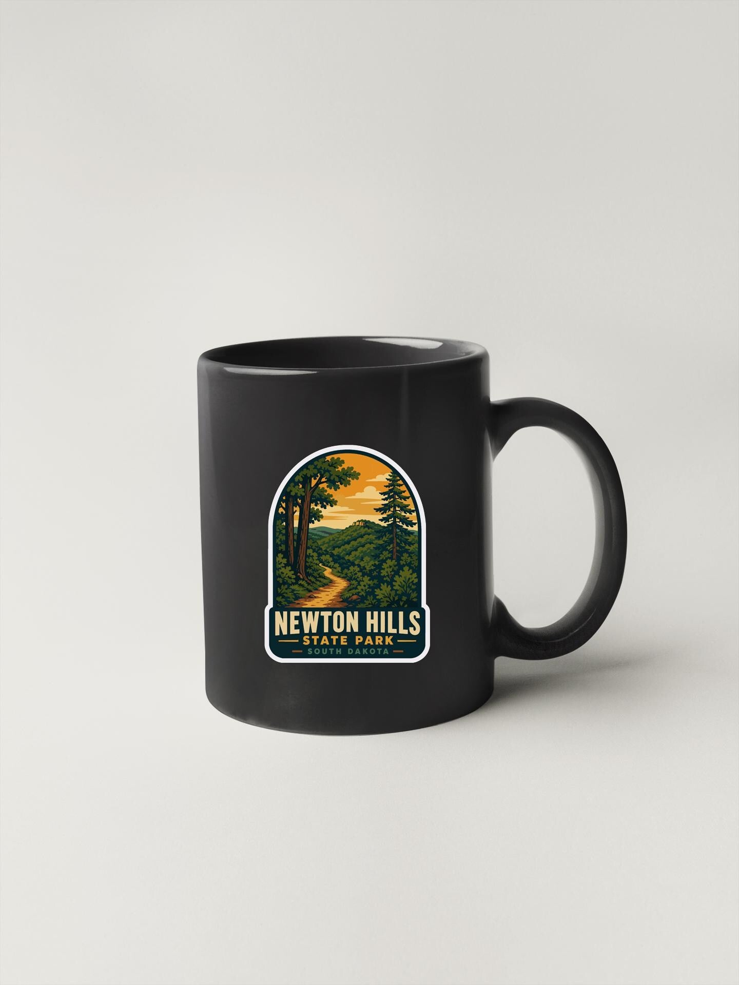 A black coffee mug with a label that says "Newton Hills State Park".