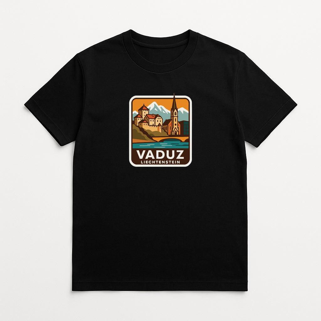 A black t-shirt with a graphic design depicting a scenic landscape with mountains, buildings, and a church spire. The text "VADUZ LIGHTENSTEIN" is displayed below the image.