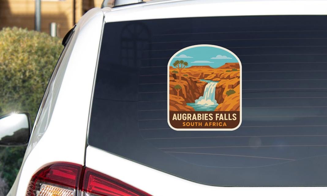 A sticker on the rear window of a car that says "Augrebies Falls South Africa".
