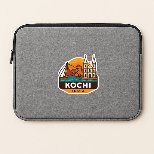 A gray laptop sleeve with a sticker depicting a cityscape and the text "Kochi India".