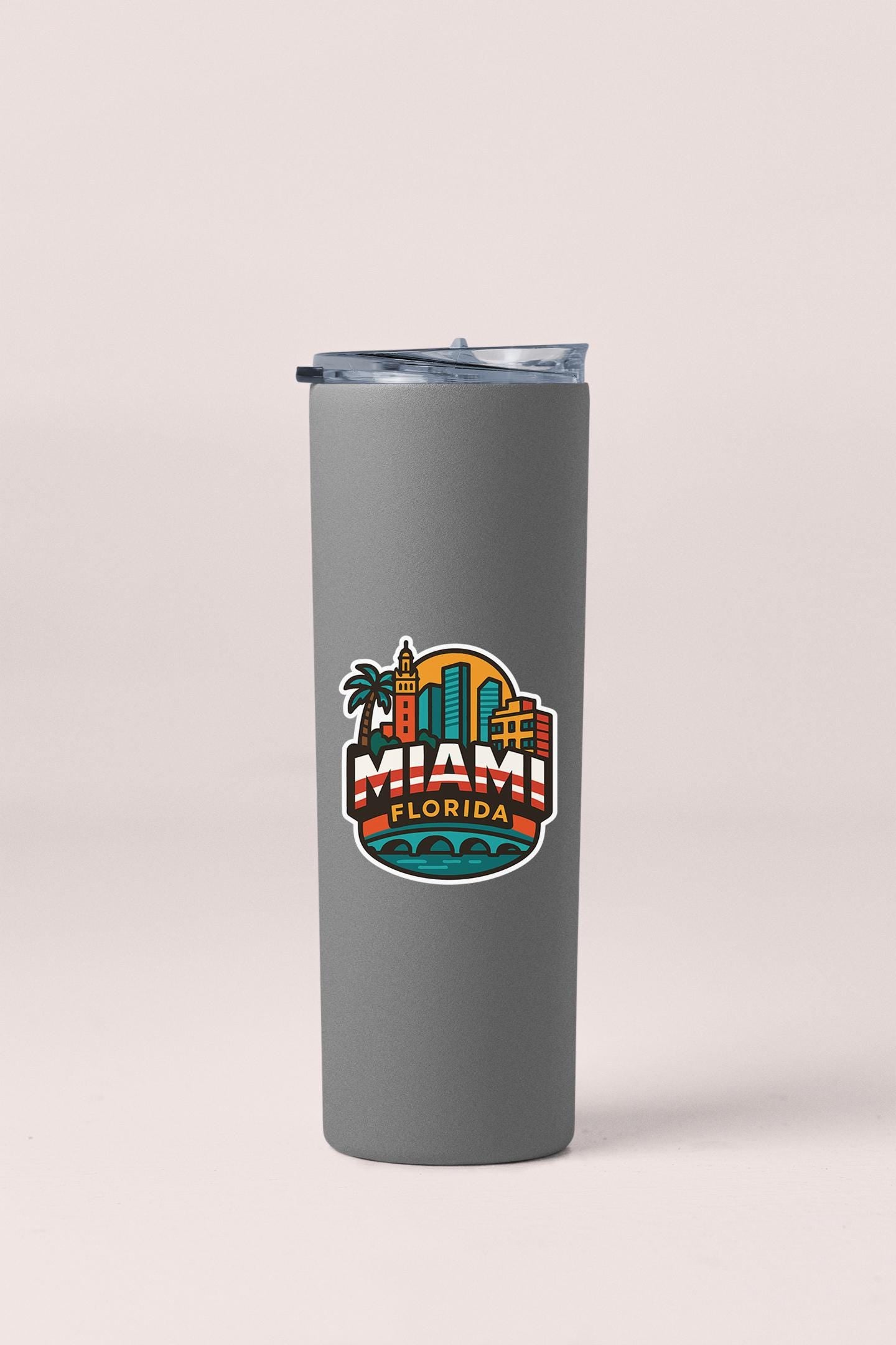 a gray tumbler cup with a miami beach scene on it