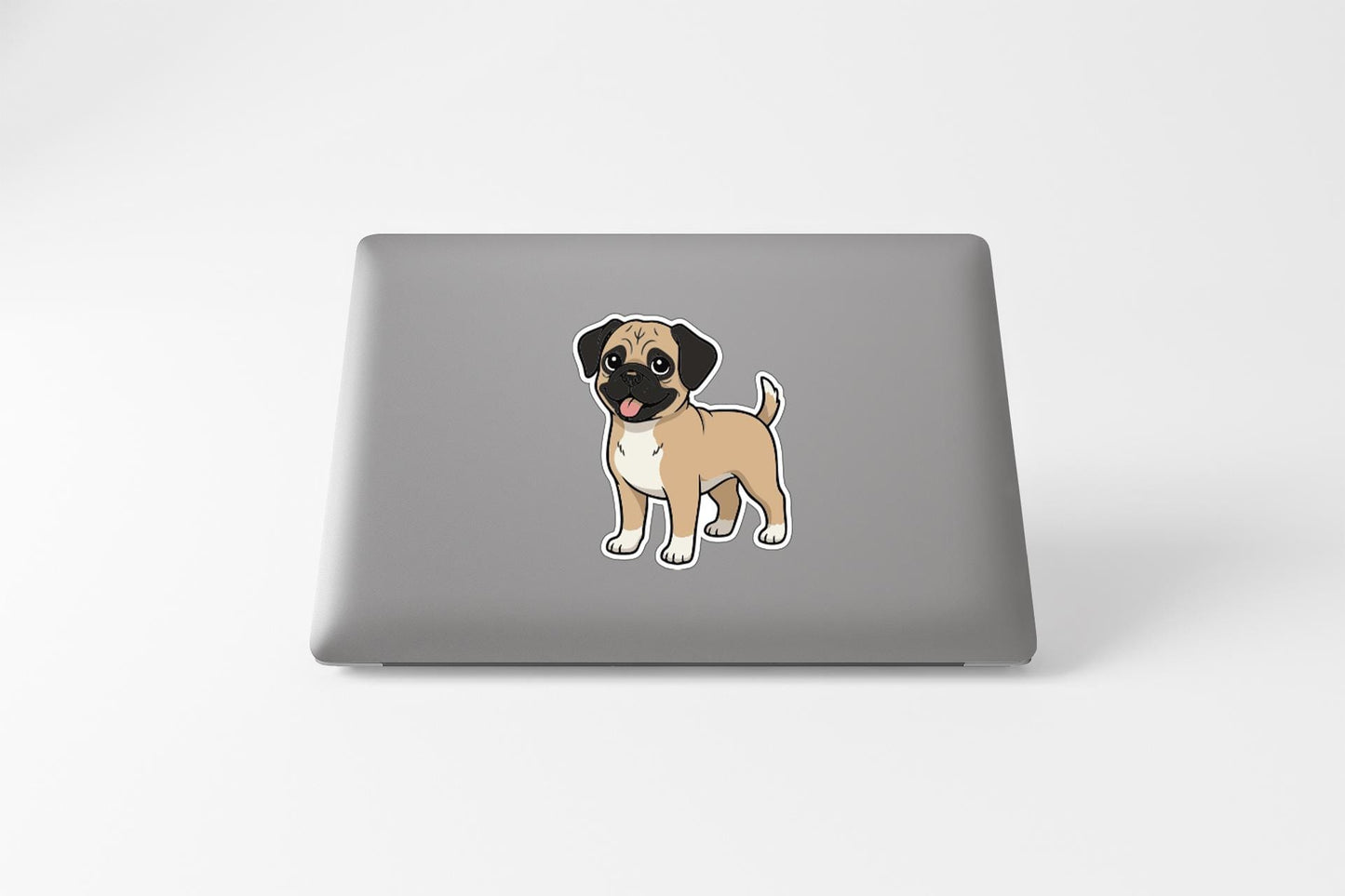 A sticker of a cartoon dog on the back of a laptop computer.