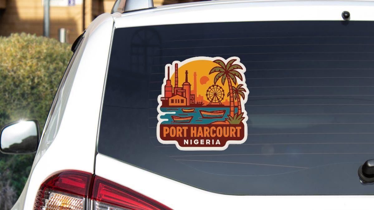 A sticker on the rear window of a car, depicting a cityscape with a ferris wheel and palm trees, along with the text "PORT HARCOURT NIGERIA".