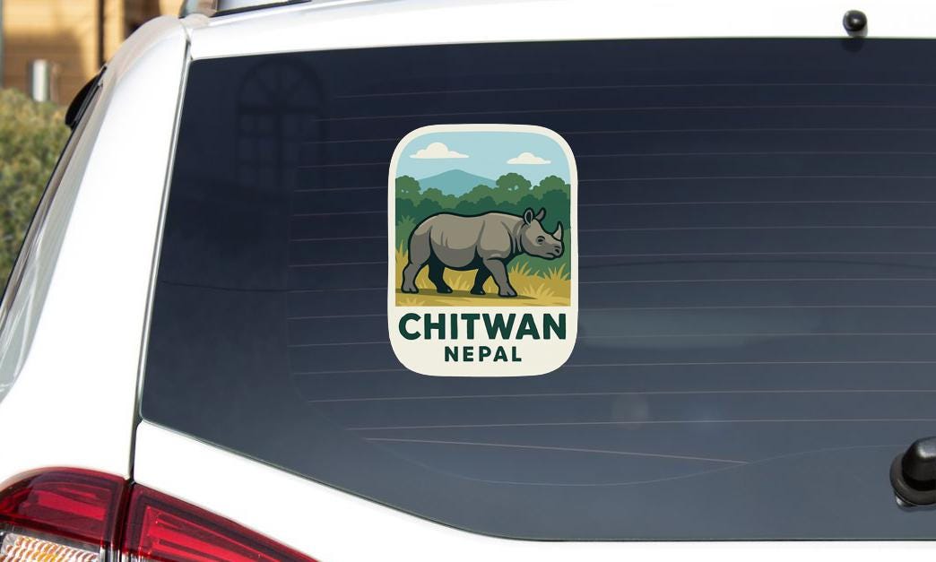a sticker on the rear window of a car that says "CHITWAN NEPAL".