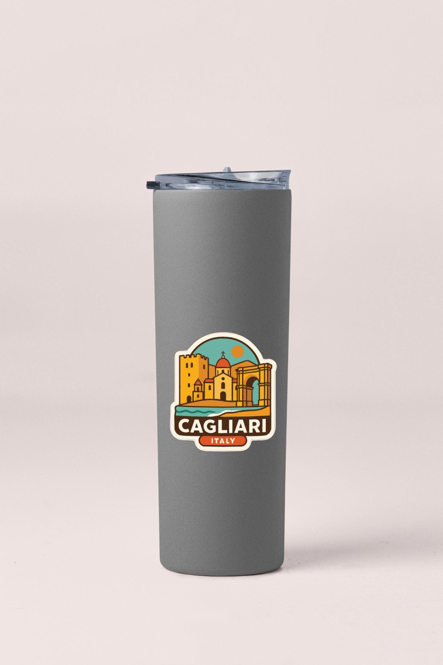 A gray insulated tumbler with a sticker depicting the city of Cagliari, Italy.