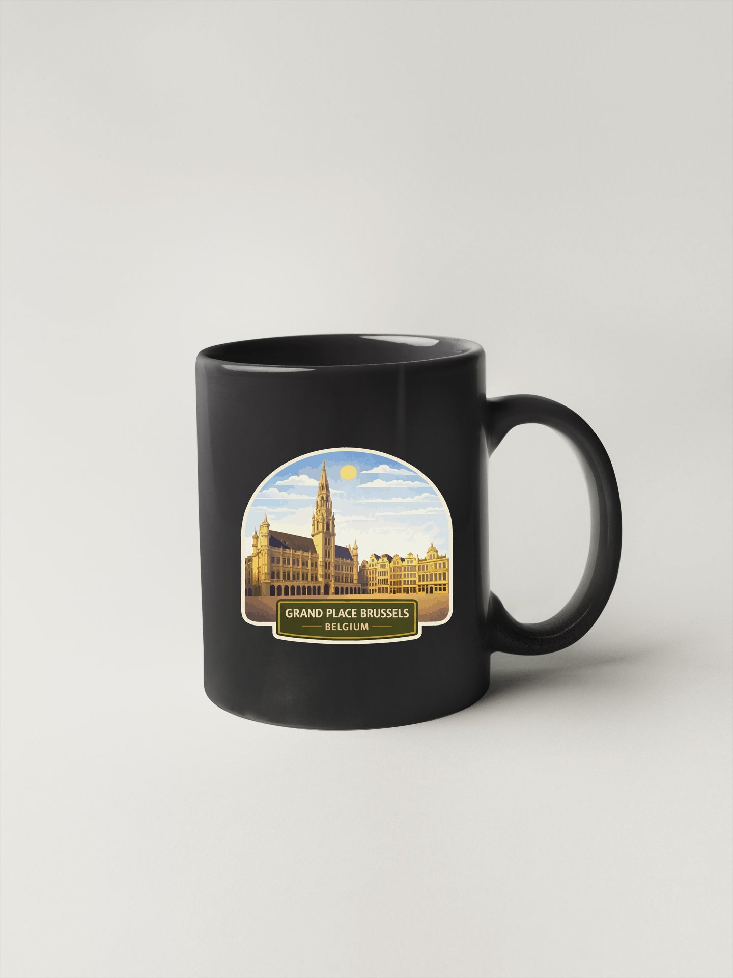 A black coffee mug with a printed image of the Grand Place in Brussels, Belgium.