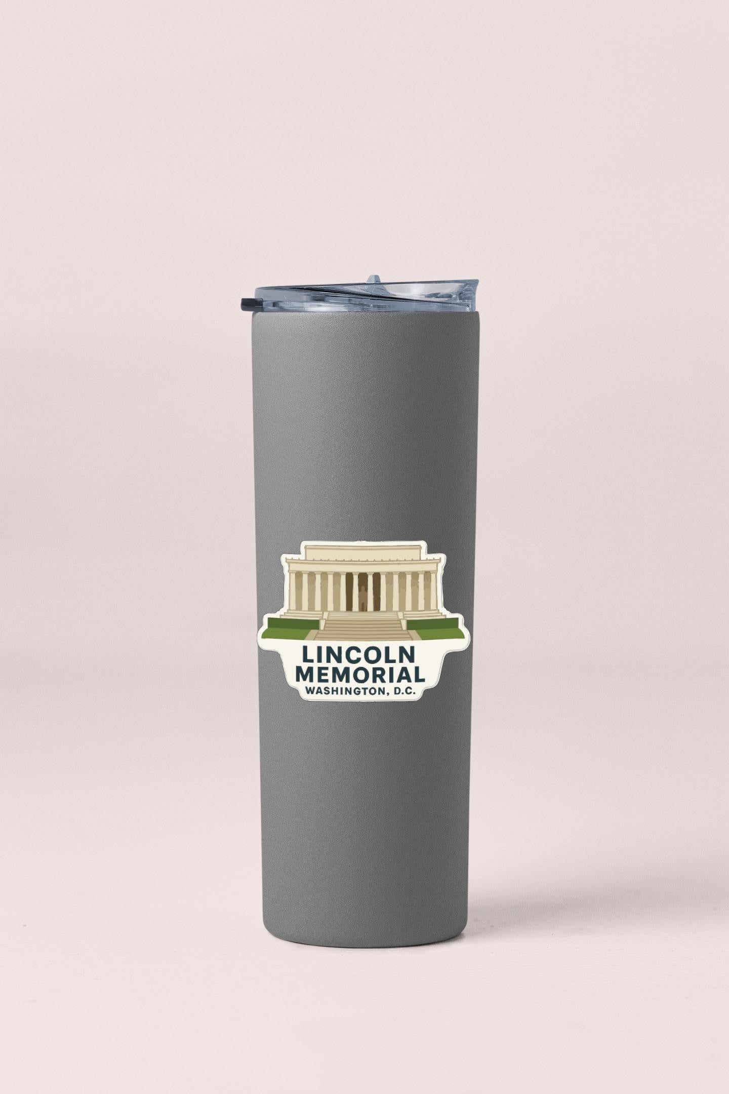 A gray tumbler with a sticker depicting the Lincoln Memorial in Washington, D.C.