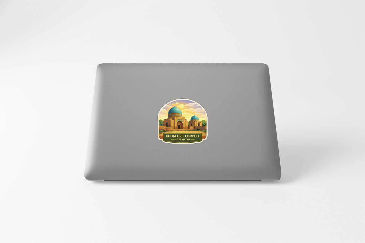 a sticker with an illustration of a building, likely a mosque, on the back of a laptop.