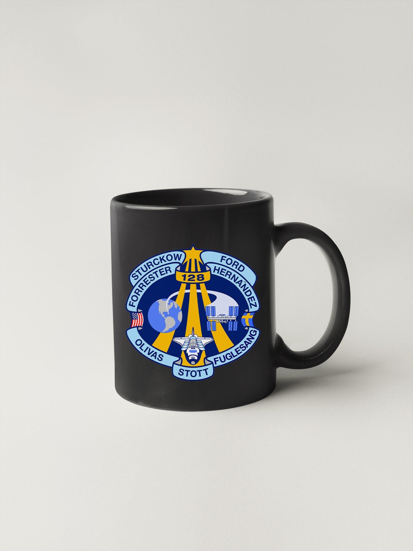 a black mug with a blue and yellow emblem on it