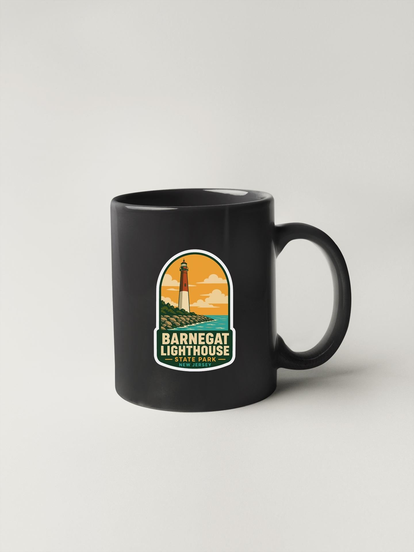 A black coffee mug with a graphic design featuring a lighthouse and the text "Barnes Lighthouse" printed on it.