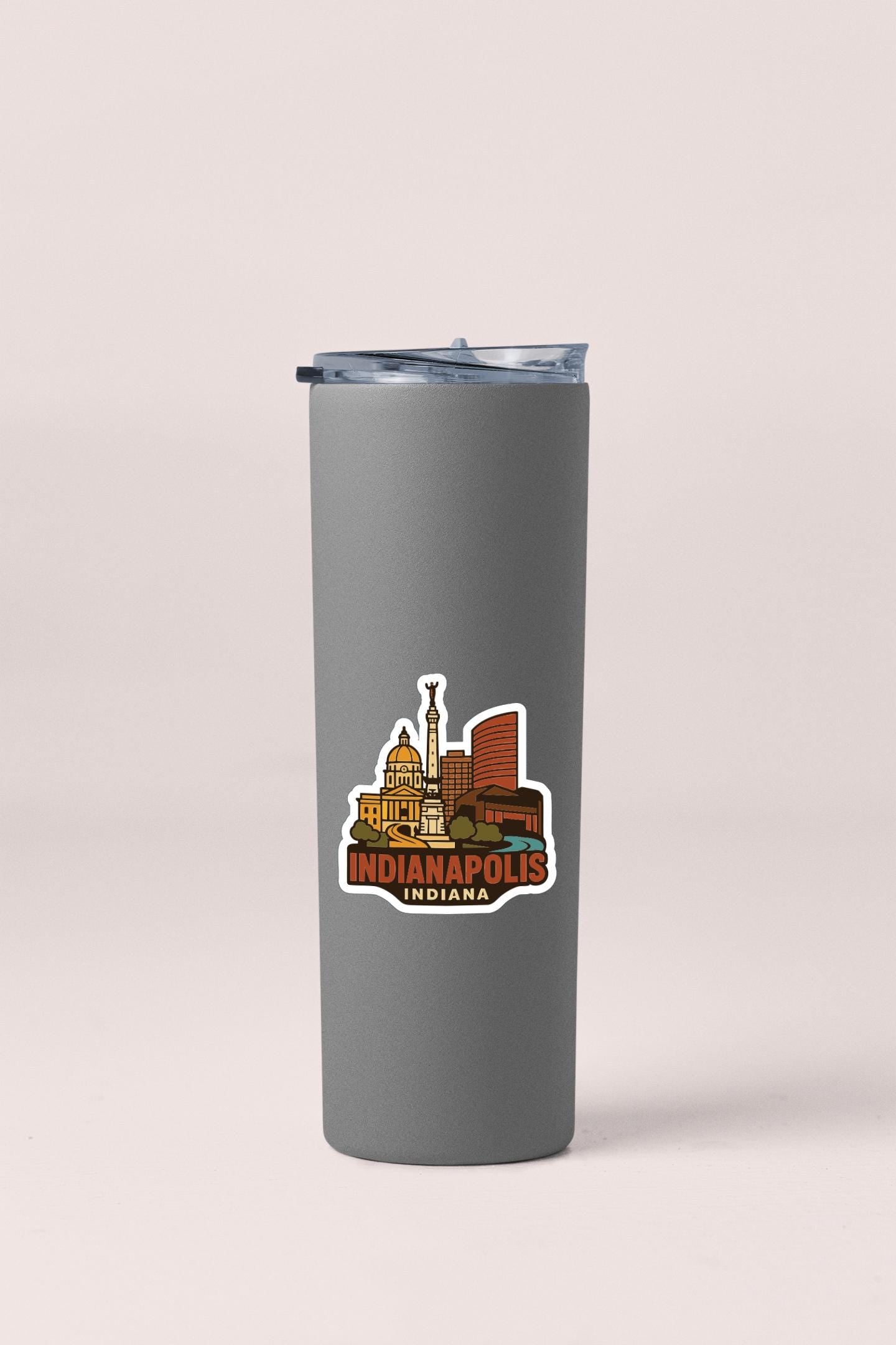 A gray insulated tumbler with a printed sticker depicting the skyline of Indianapolis, Indiana.