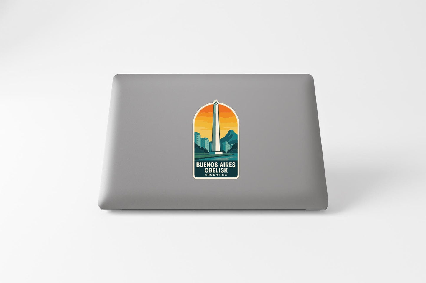 a sticker on the back of a laptop with a graphic of the Washington Monument and the text "Buenos Aires Obelisk" printed on it.
