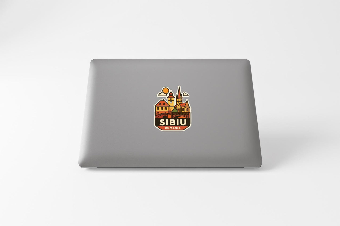a sticker with a cityscape and the word "SIBU" on the back of a laptop.
