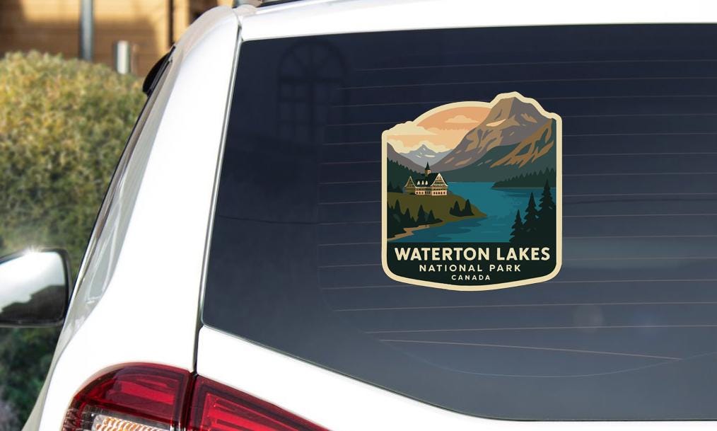 A sticker on the rear window of a car that says "WATERTON LAKES NATIONAL PARK CANADA".
