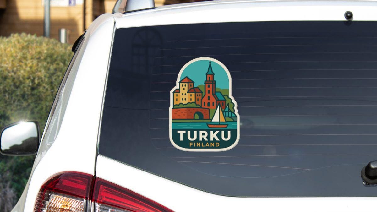 A sticker on the rear window of a car, depicting a cityscape with a church and a sailboat, representing the city of Turku, Finland.
