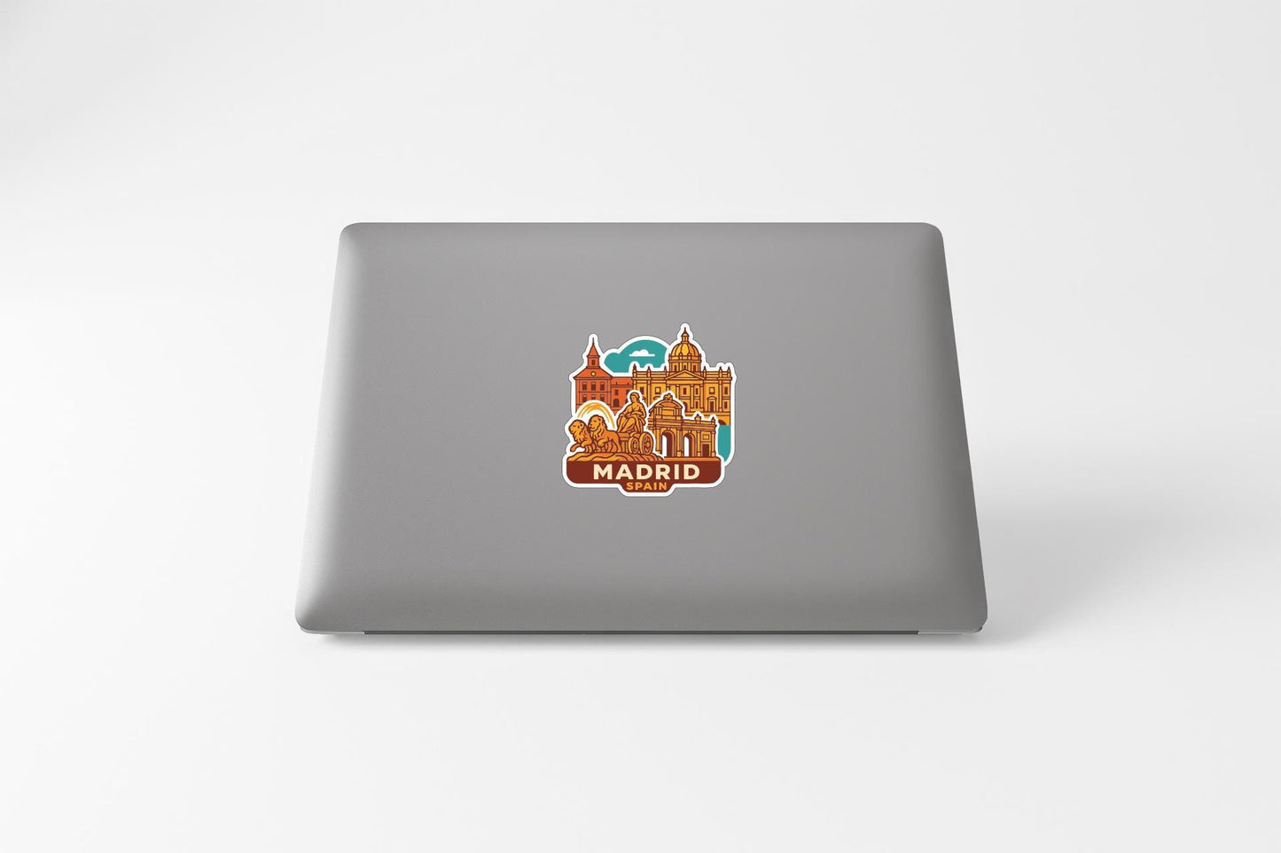 a sticker of the city of Madrid on the back of a laptop computer.