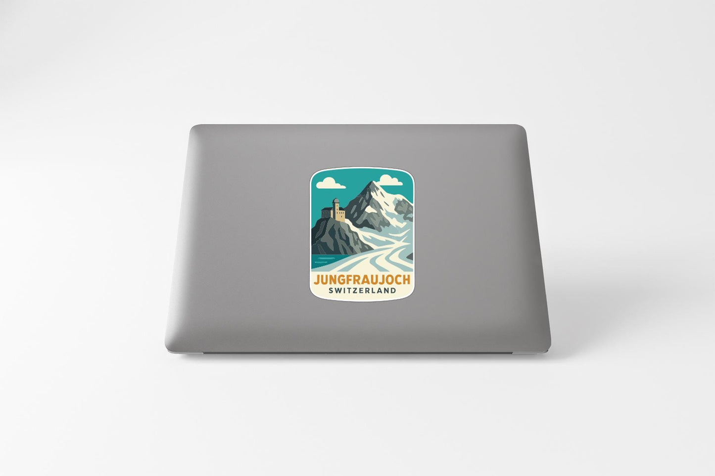 A sticker depicting a mountain landscape with a lighthouse on top, representing the location of Jungfrauich, Switzerland.