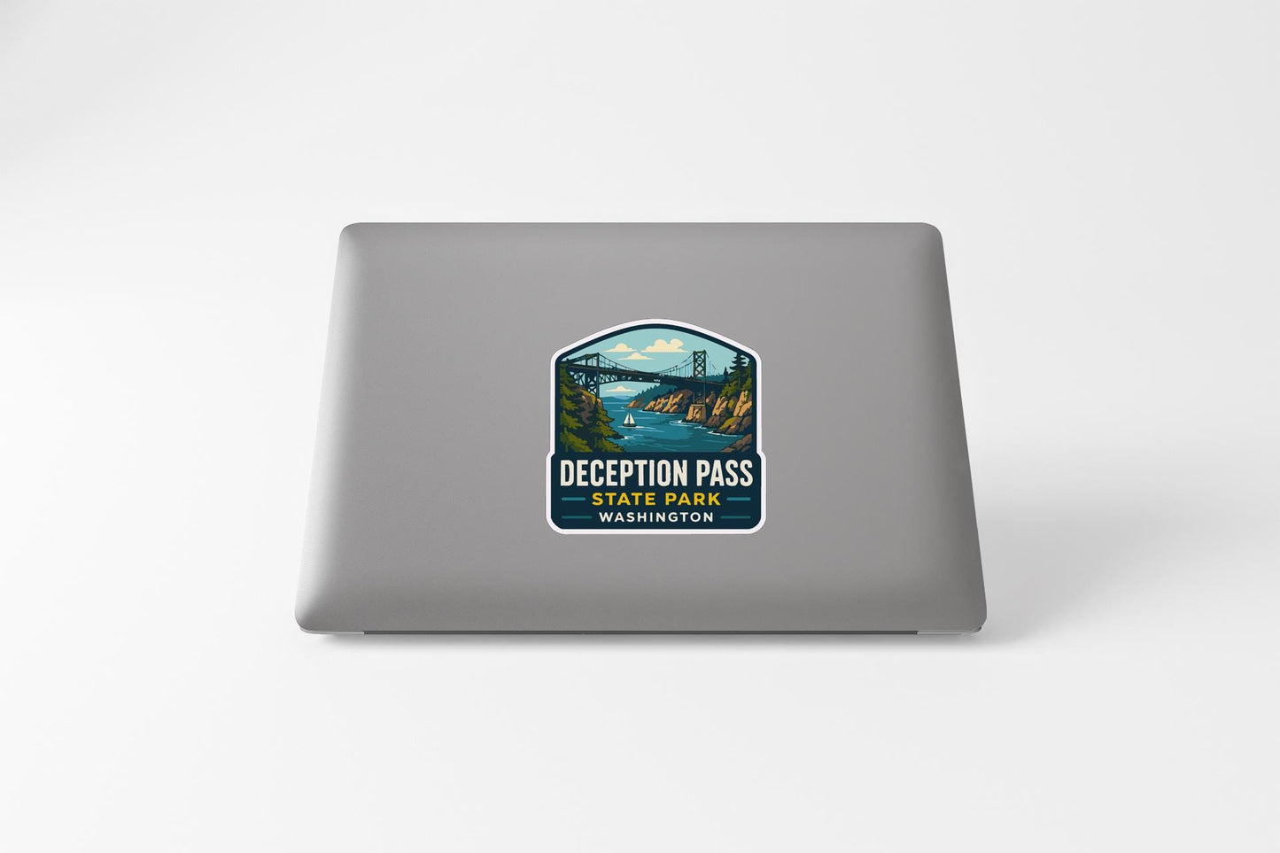 a sticker on a laptop that says "Deception Pass State Park Washington".