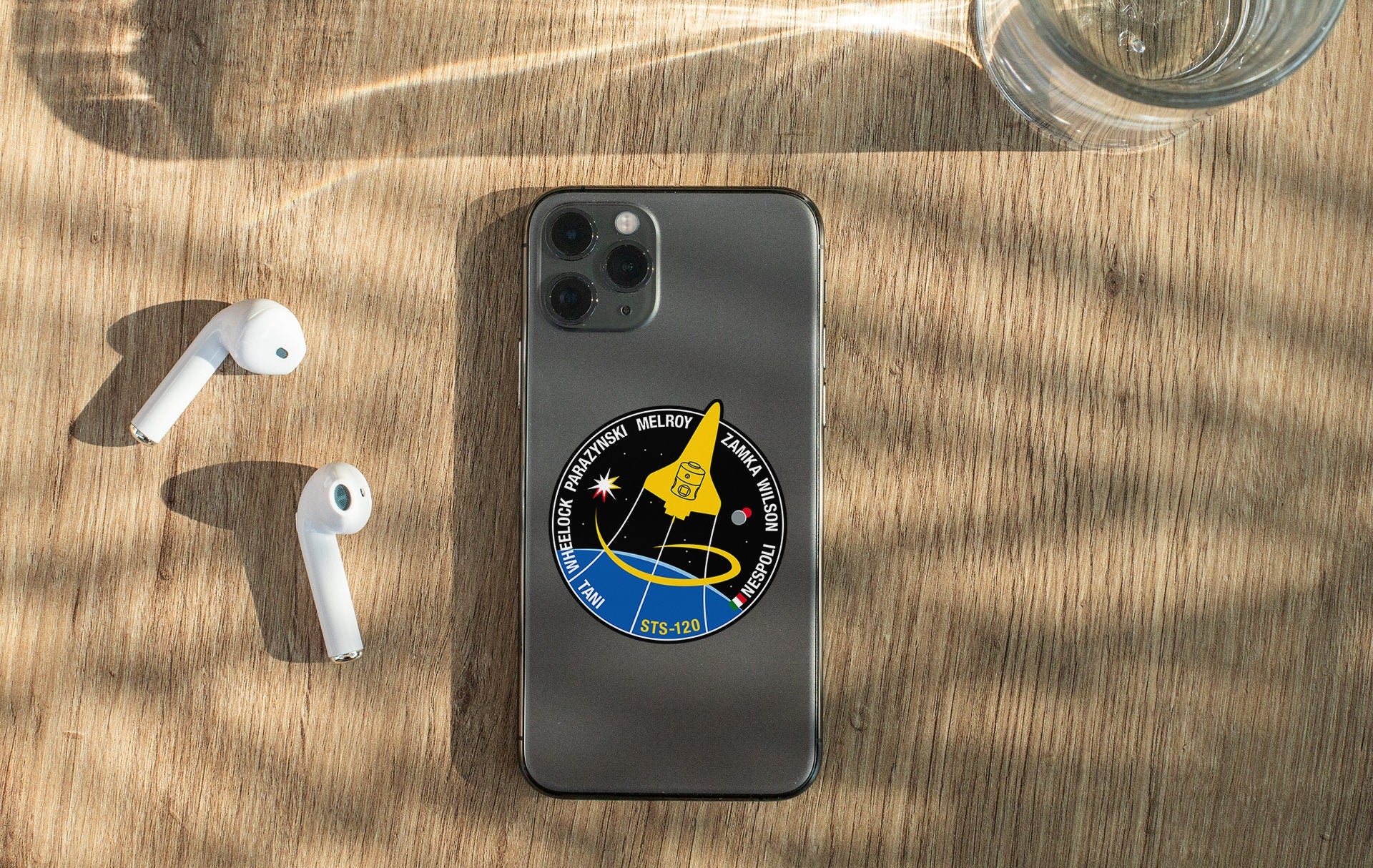 a phone and ear buds sitting on a table