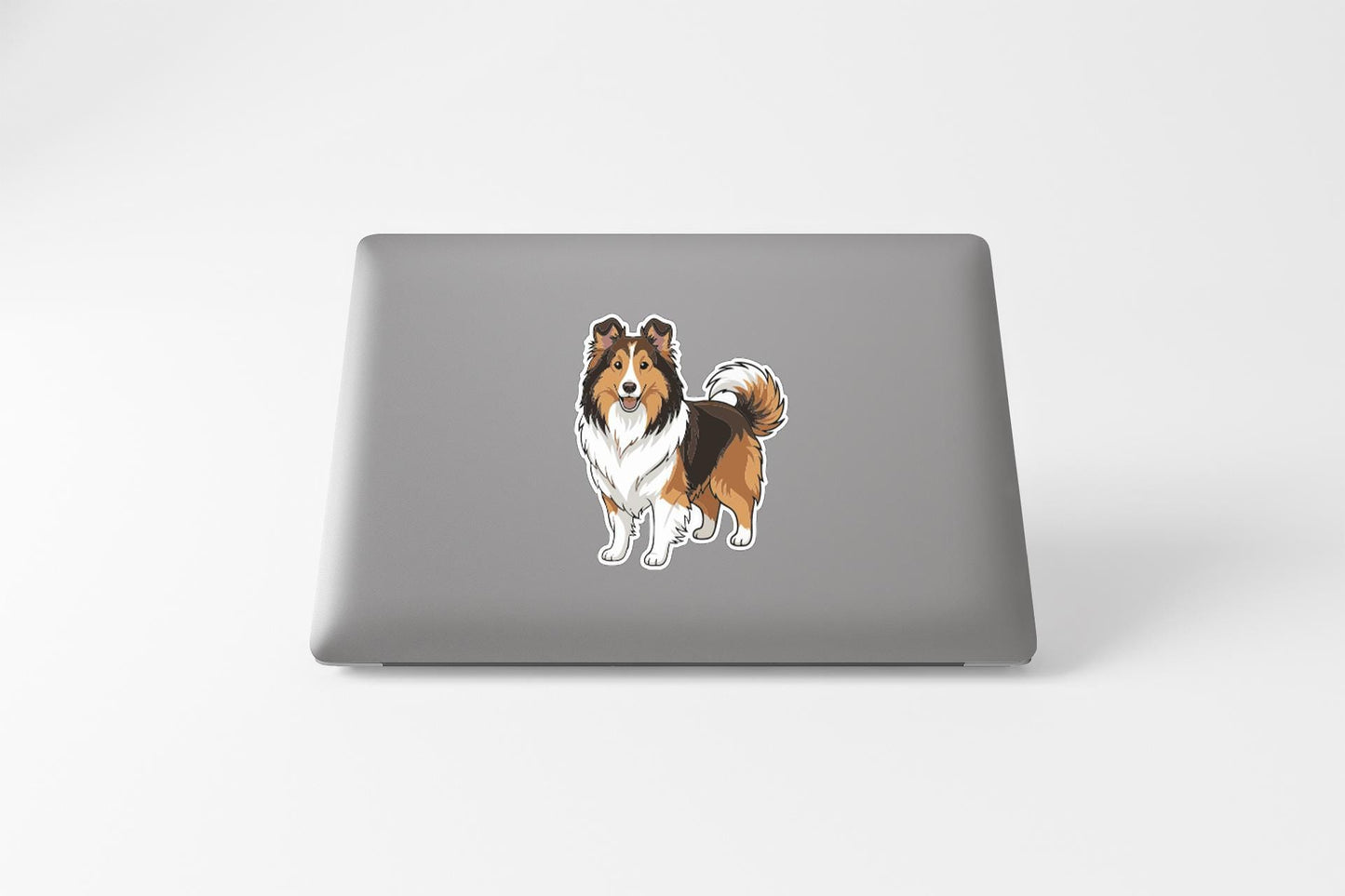A sticker of a dog on the back of a laptop computer.
