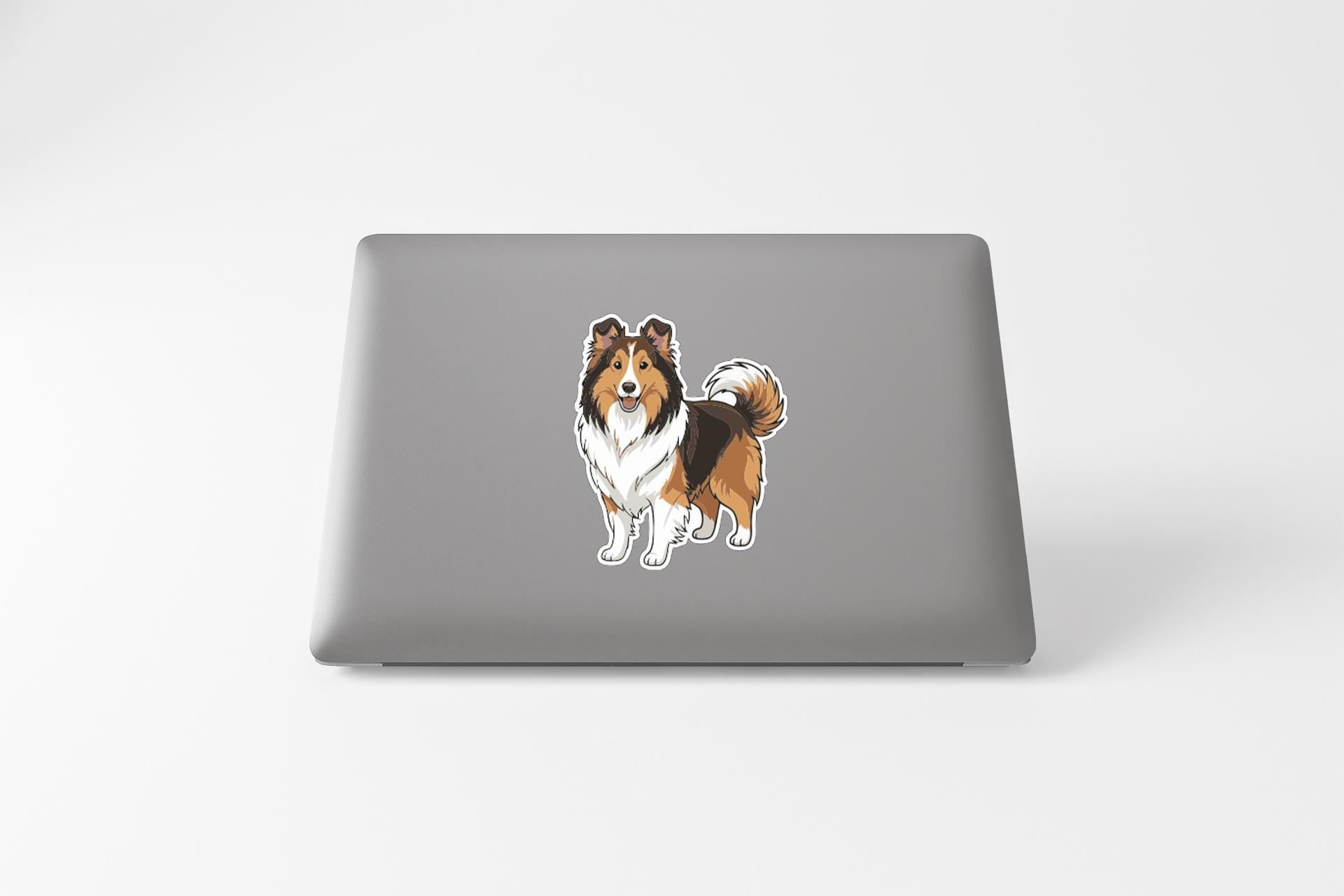 A sticker of a dog on the back of a laptop computer.