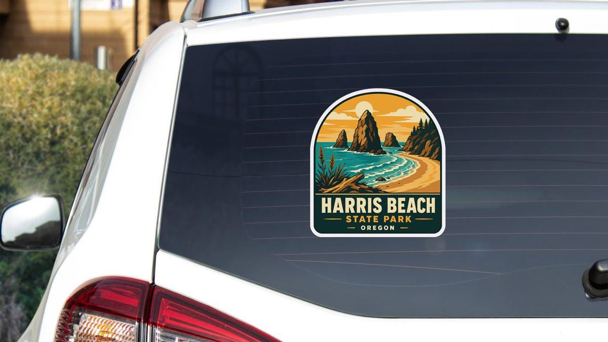 A sticker on the rear window of a car that says "HARRIS BEACH STATE PARK OREGON".
