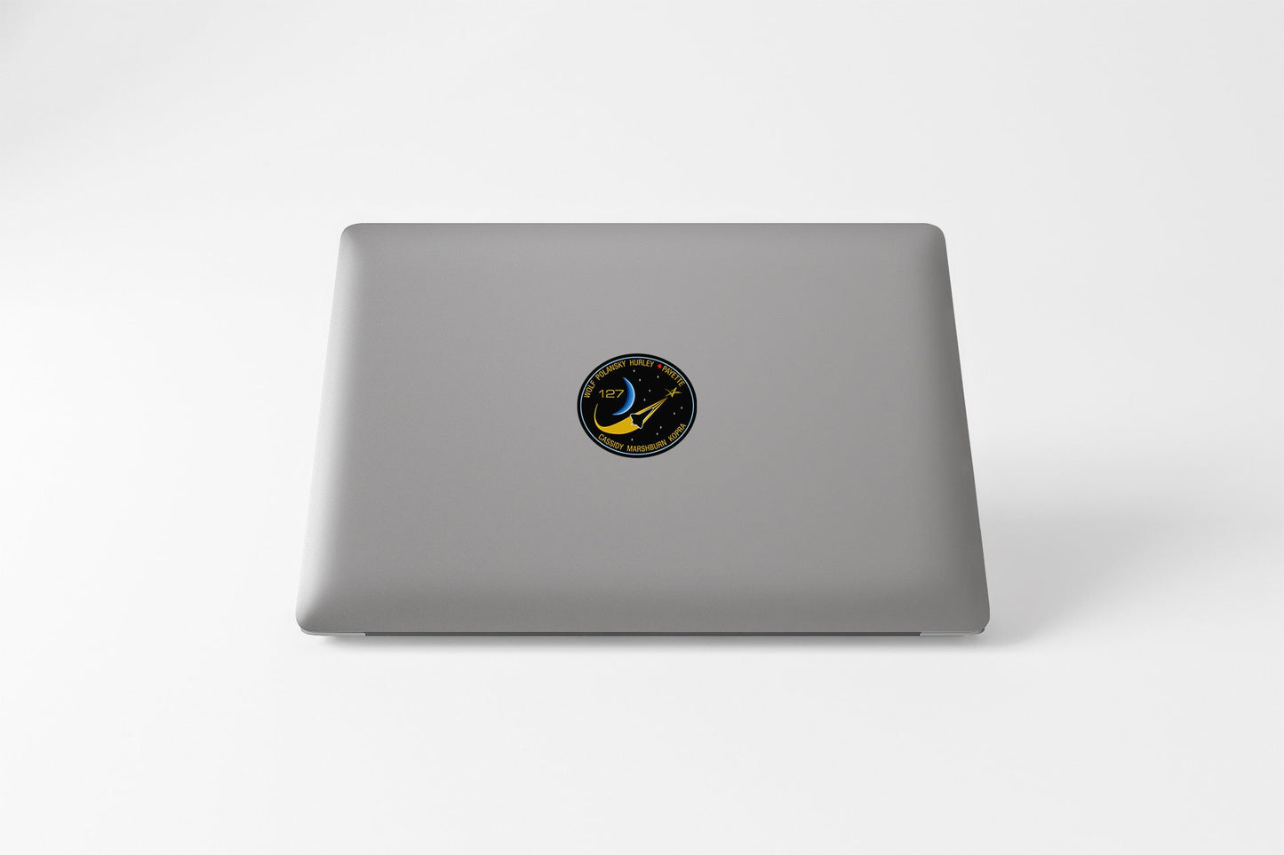 a laptop with a sticker of a bird on it