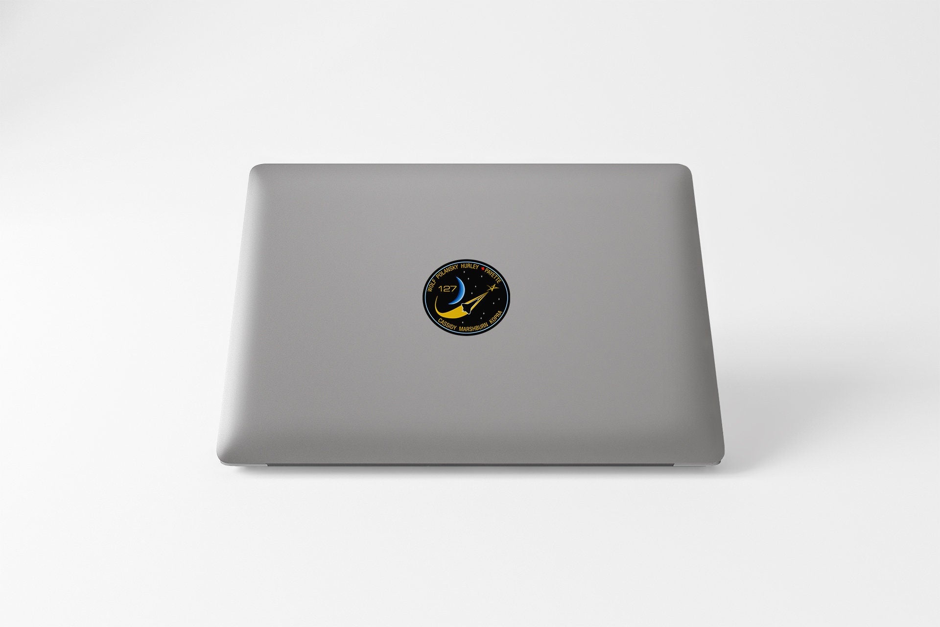 a laptop with a sticker of a bird on it