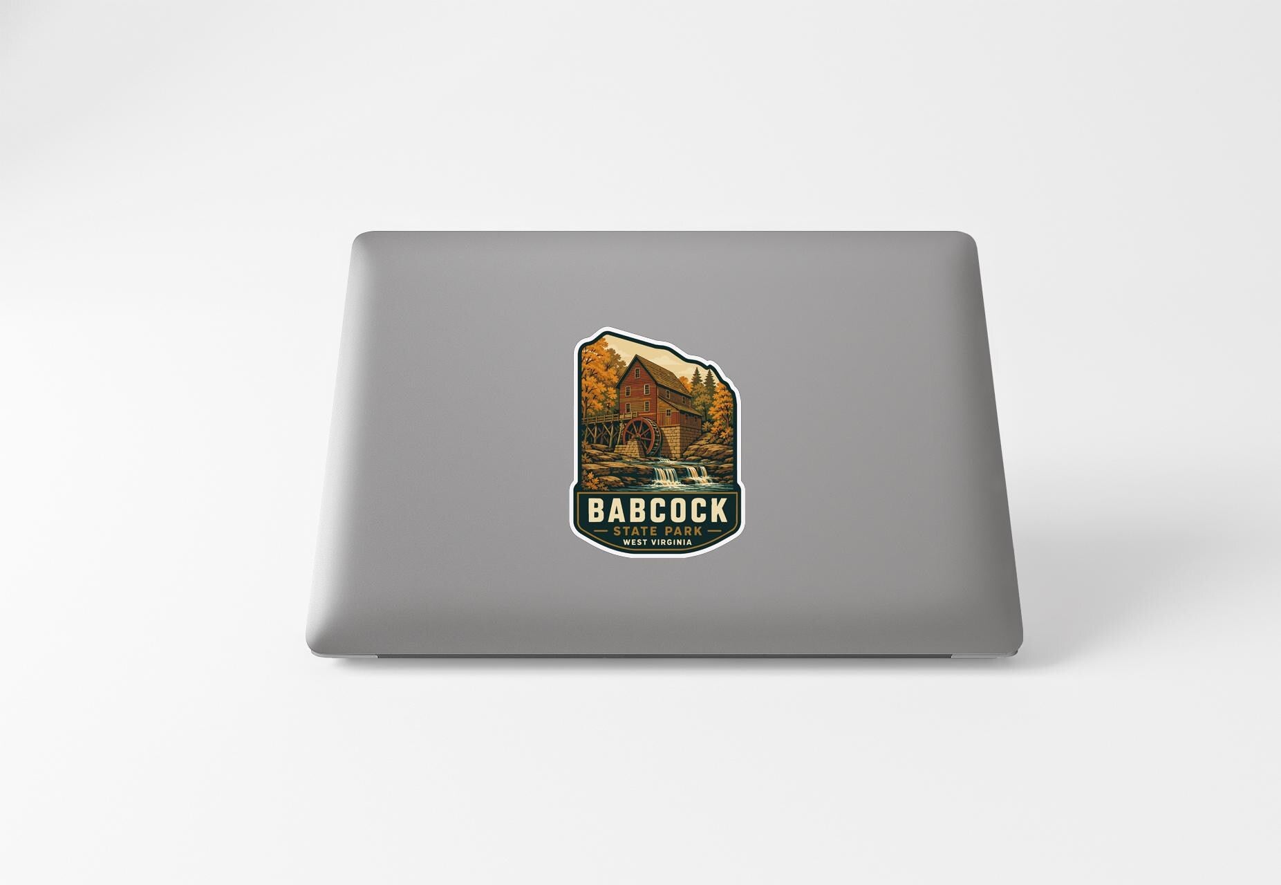 a sticker with a scenic illustration of a building and a waterfall, along with the text "BACOCK WEST PARK".