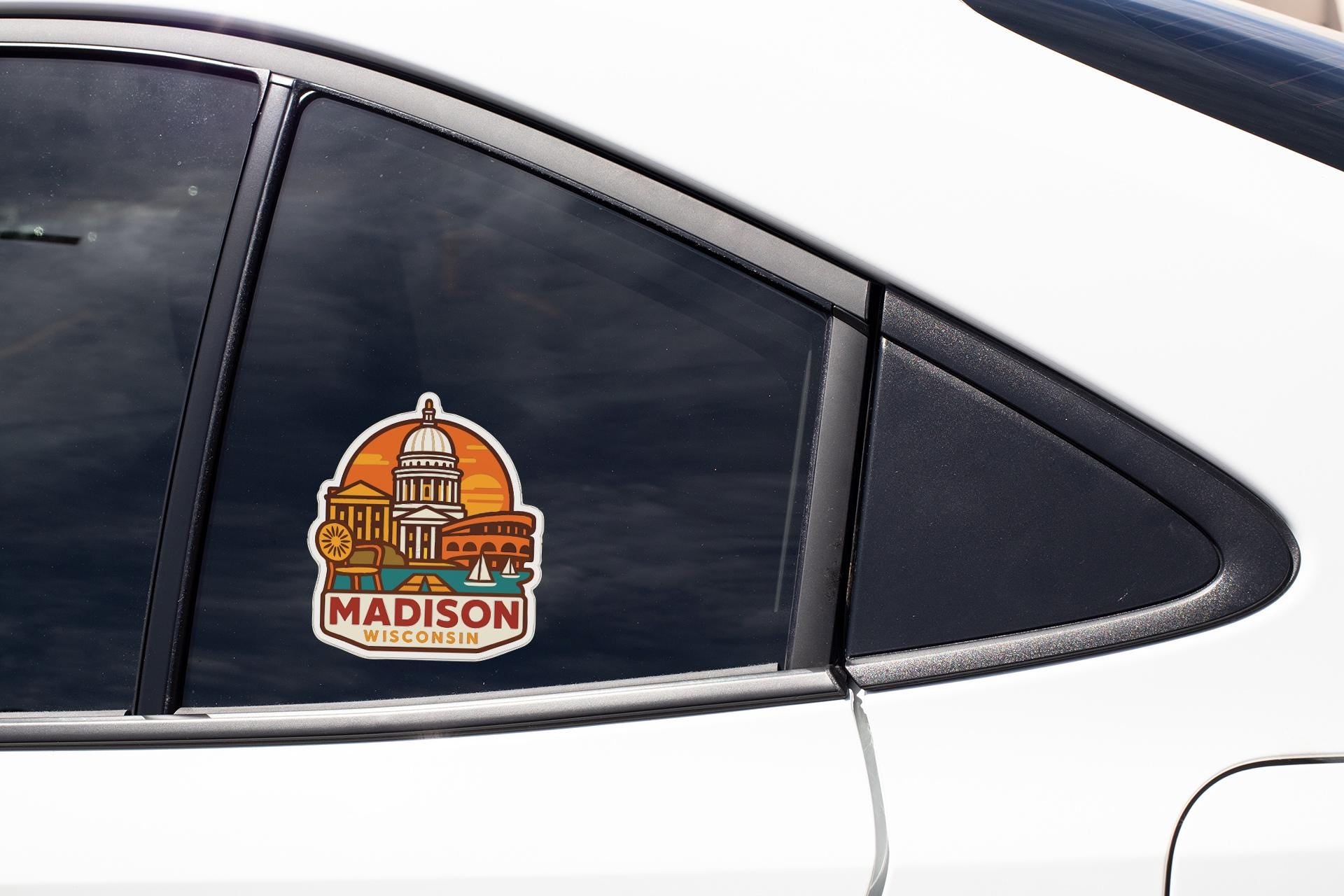 A sticker on the side of a car window, depicting the Madison, Wisconsin state capitol building.