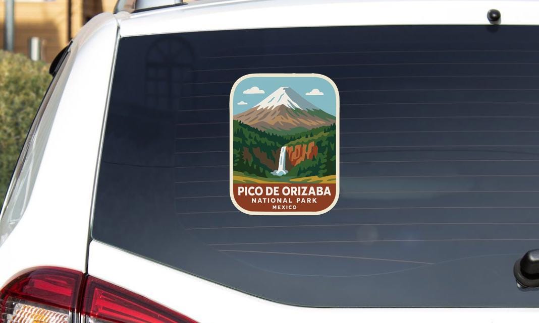 A sticker on the rear window of a car, depicting a mountain landscape with a waterfall, representing the Pico de Orizaba National Park in Mexico.