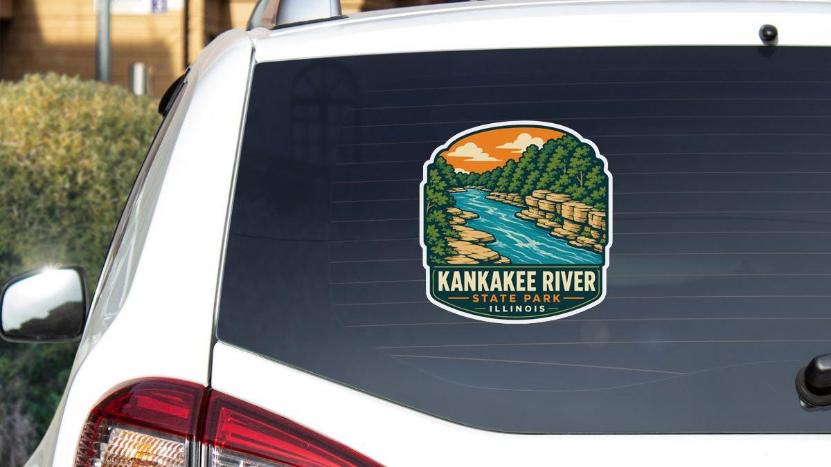 A sticker on the rear window of a white vehicle, depicting a scenic view of the Kankakee River in Illinois.
