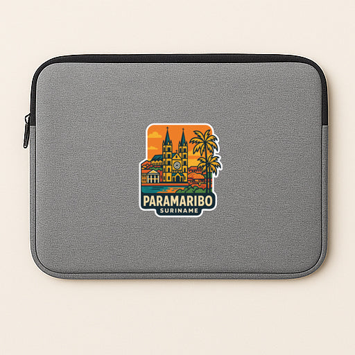 A gray laptop sleeve with a colorful sticker depicting a cityscape and palm trees, along with the text "PARAMARIO SURINAME".