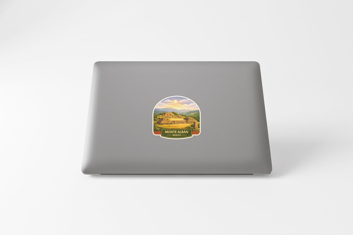 a sticker with a scenic landscape on the back of a laptop.